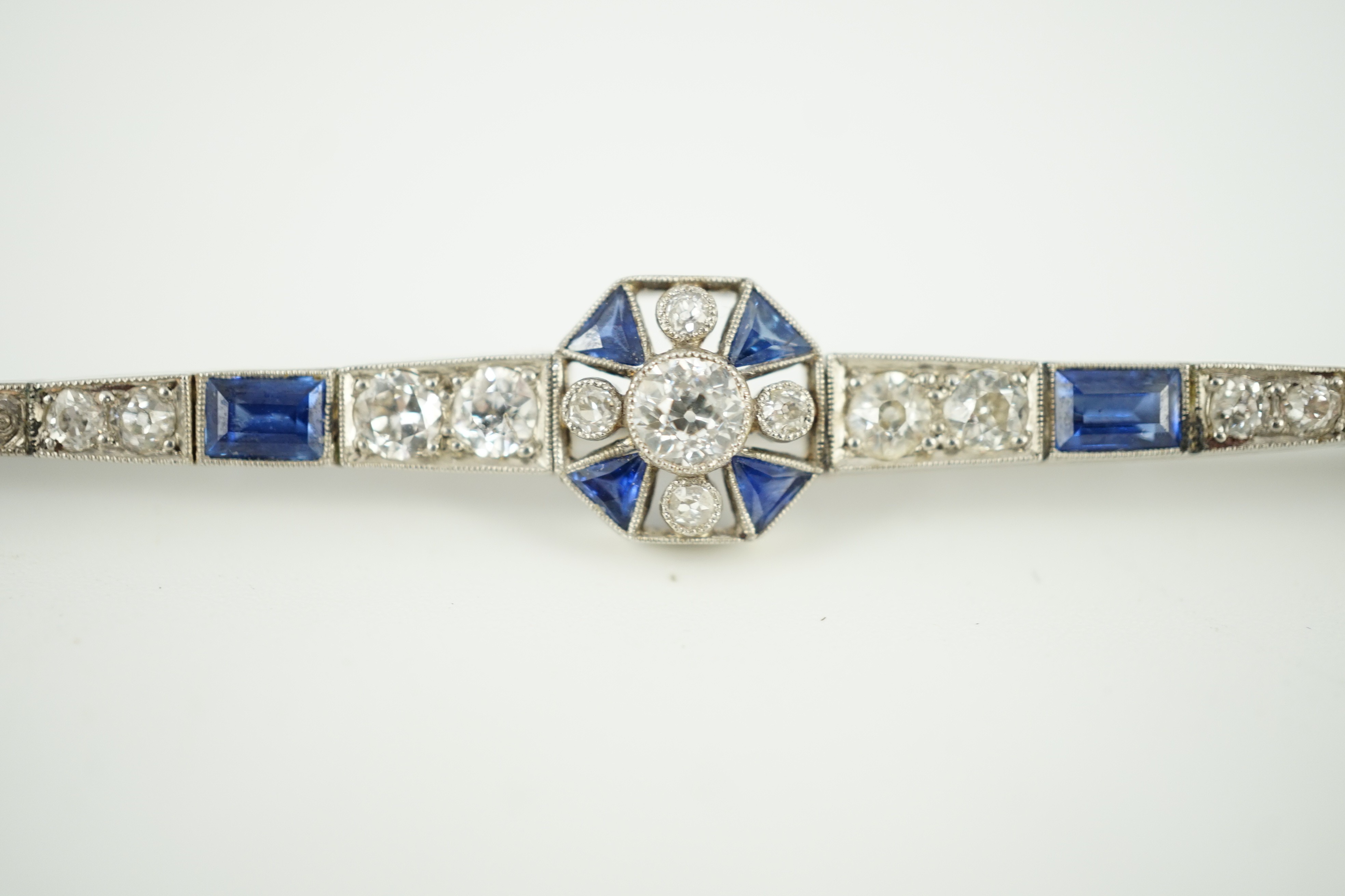 A 1920's/1930's white gold, sapphire and diamond cluster set bar brooch